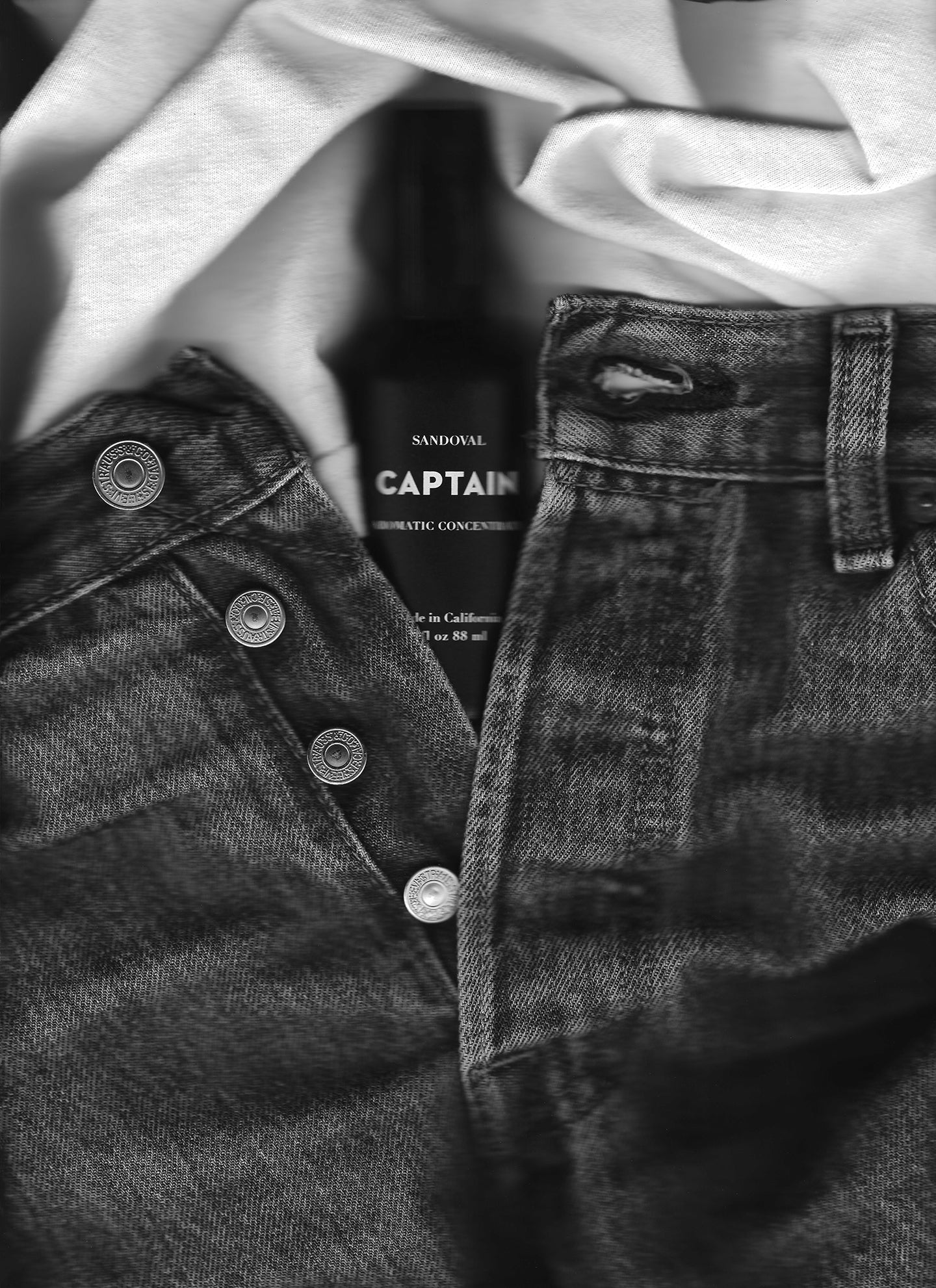 Image of someone's jeans unbuttoned with Captain aromatic concentrate bottle tucked in the crotch. Our nod to the sensual nature of all natural scents derived from essential oils. 