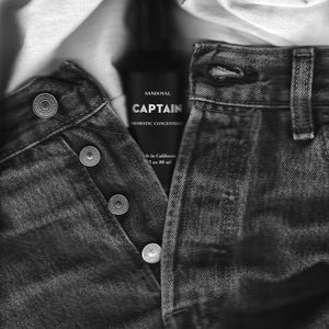 Image of someone's jeans unbuttoned with Captain aromatic concentrate bottle tucked in the crotch. Our nod to the sensual nature of all natural scents derived from essential oils. 