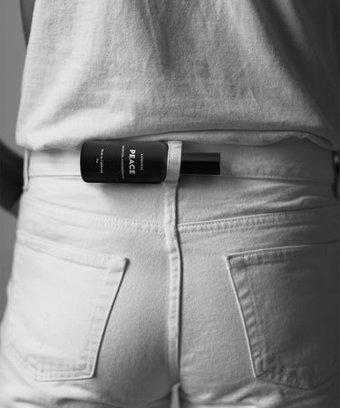 peace aromatic concentrate mist on the go in a belt loop on the back os a pair of white jeans