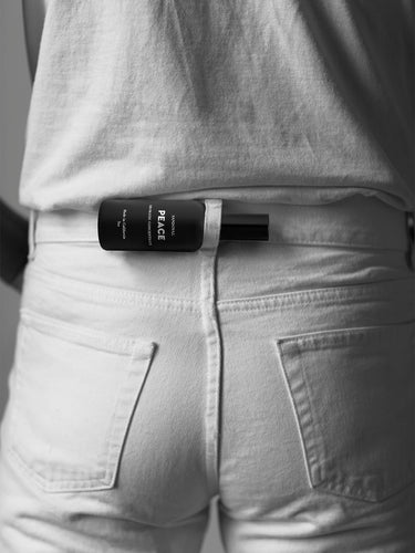 peace aromatic concentrate mist on the go in a belt loop on the back os a pair of white jeans